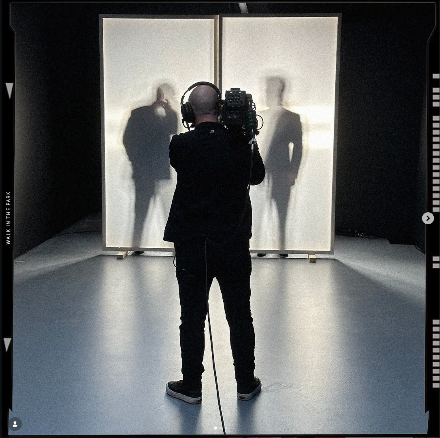 Camera operator shooting a lightbox art installation in the studio