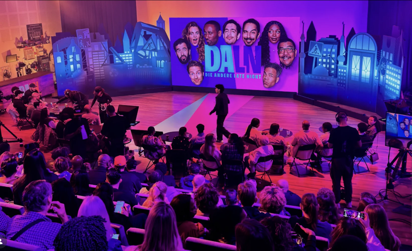 DALV live studio audience with performers on stage and city skyline set design