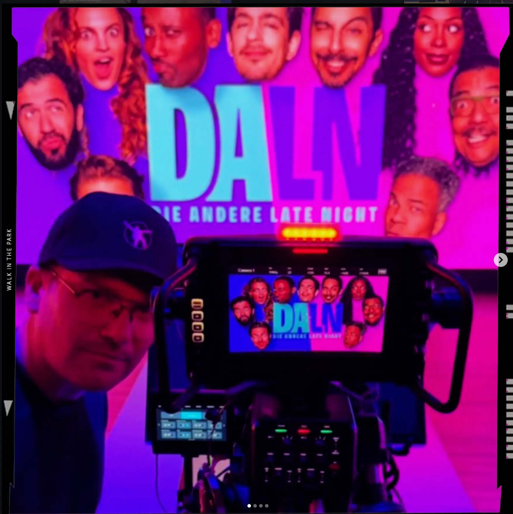 Camera operator in front of the DALN set backdrop