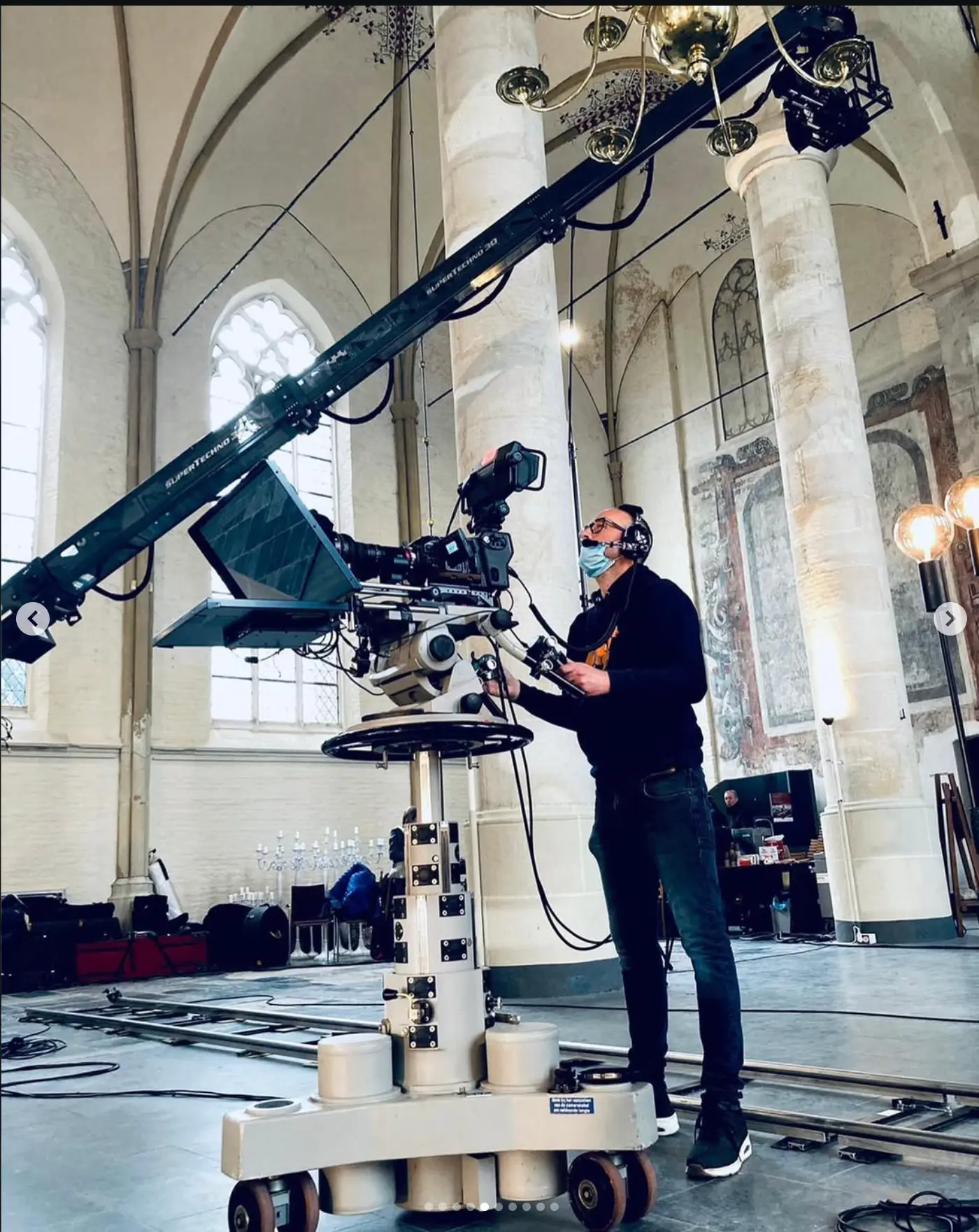 Camera operator on a crane inside a cathedral