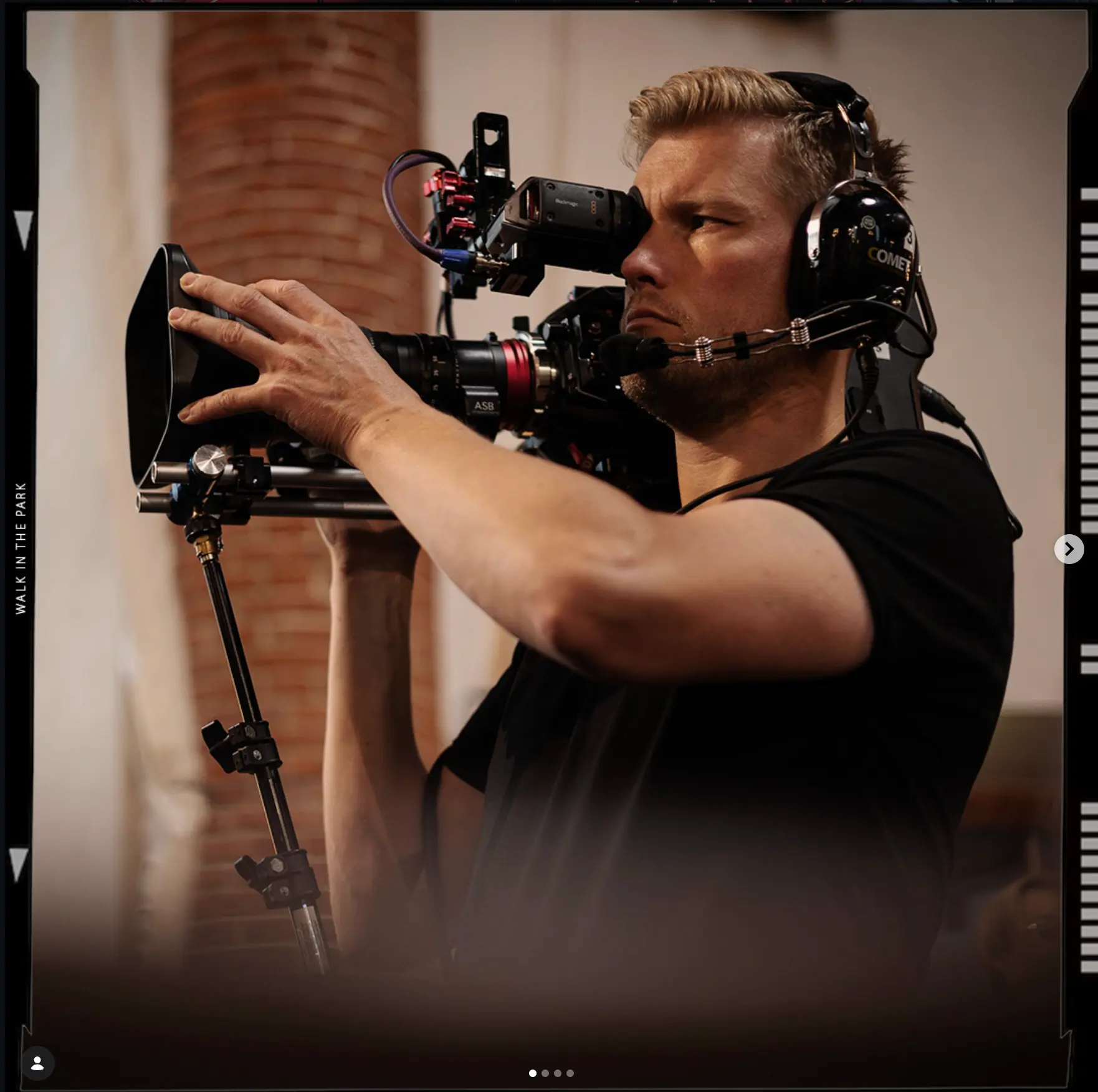 Camera operator framing a shot with a cinema rig